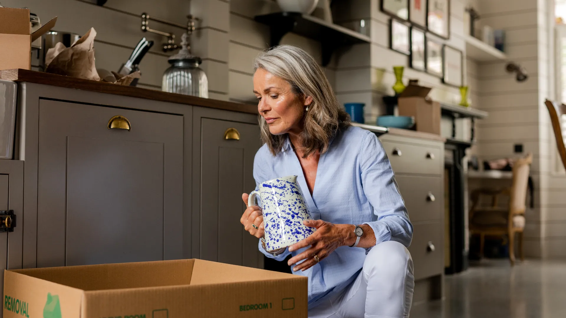 woman packing a jug in kitchen