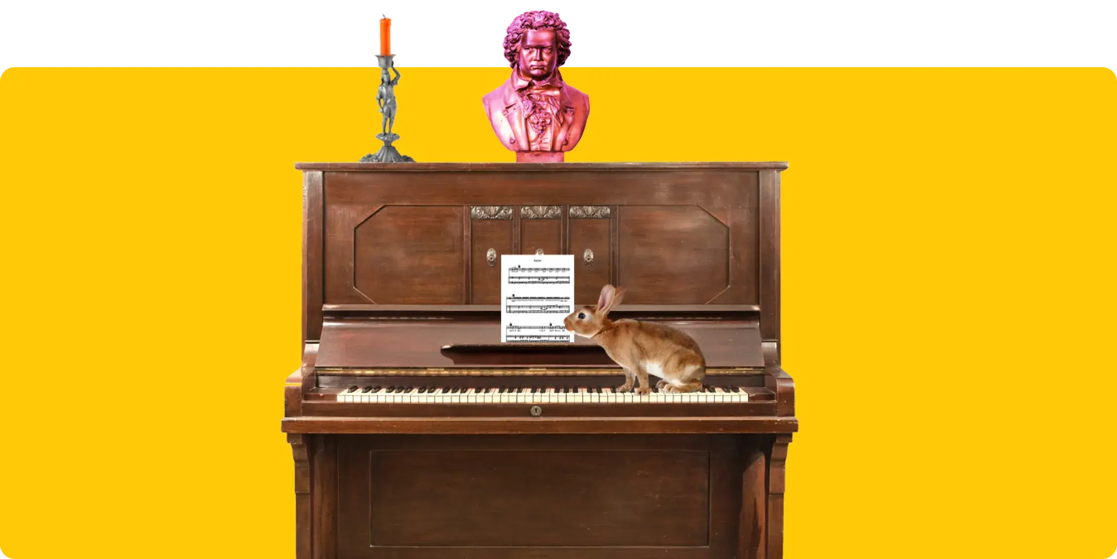Funny image of a piano with quirky objects. There's a rabbit, candlestick holder and a statue resting on it 